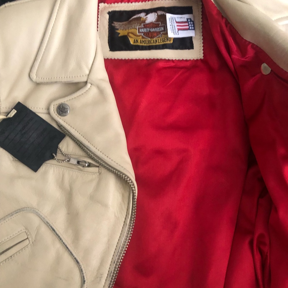 Harley Davidson leather motorcycle jacket. Worn, beige leather with red lining.